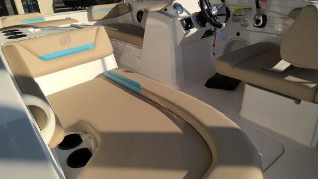 Slide: The Image of 2025 Hurricane SunDeck Sport 205 OB interior with beige seating and steering console. - 10