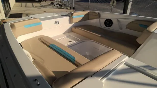 Slide: The Image of 2025 Hurricane SunDeck Sport 205 OB boat interior with beige and blue seating. - 11
