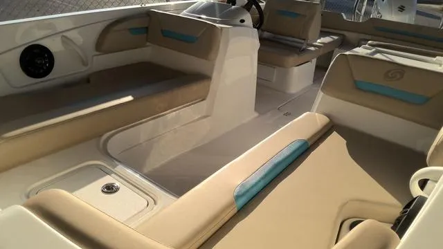 Slide: The Image of 2025 Hurricane SunDeck Sport 205 OB interior with beige and blue seating. - 12