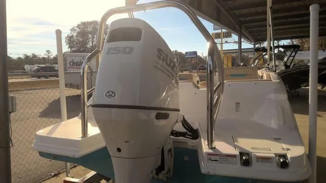Slide: The Image of 2025 Hurricane SunDeck Sport 205 OB boat with Suzuki 150 outboard motor in a marina. - 15
