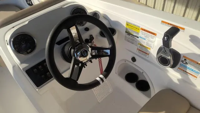Slide: The Image of 2025 Hurricane SunDeck Sport 205 OB boat dashboard with steering wheel and controls. - 18