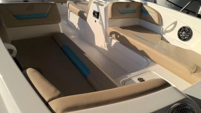Slide: The Image of 2025 Hurricane SunDeck Sport 205 OB interior with beige and blue seating, modern design. - 2