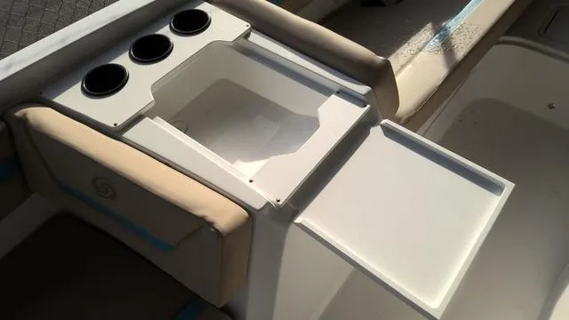 Slide: The Image of 2025 Hurricane SunDeck Sport 205 OB boat interior with cup holders and storage compartment. - 20