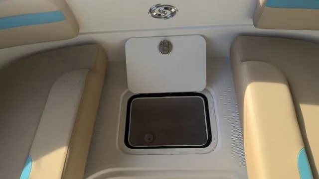 Slide: The Image of 2025 Hurricane SunDeck Sport 205 OB boat interior with storage compartment. - 21