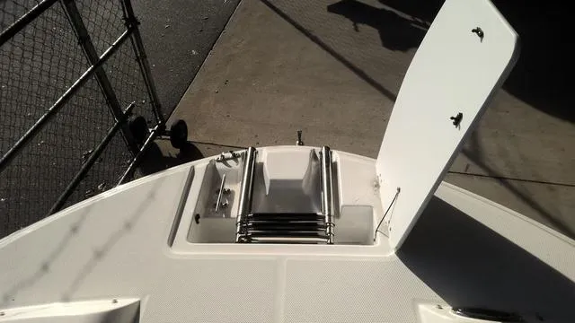 Slide: The Image of 2025 Hurricane SunDeck Sport 205 OB boat deck with open storage compartment. - 22