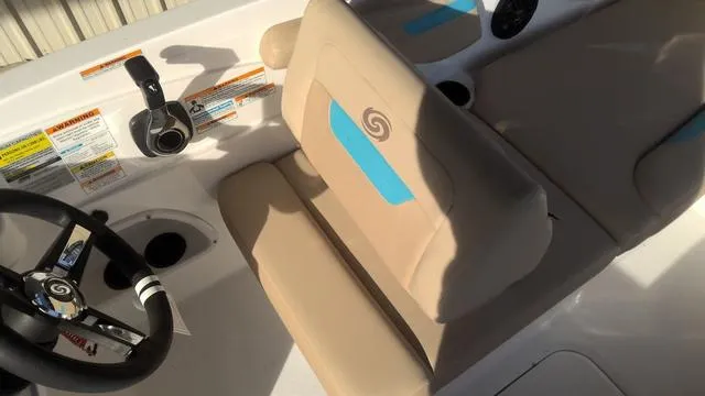 Slide: The Image of 2025 Hurricane SunDeck Sport 205 OB boat interior with beige seating and steering wheel. - 24