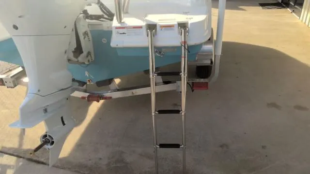 Slide: The Image of 2025 Hurricane SunDeck Sport 205 OB boat with ladder and outboard motor. - 27