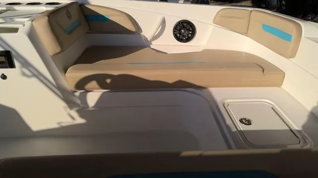 Slide: The Image of 2025 Hurricane SunDeck Sport 205 OB boat interior with beige seating and speaker. - 4