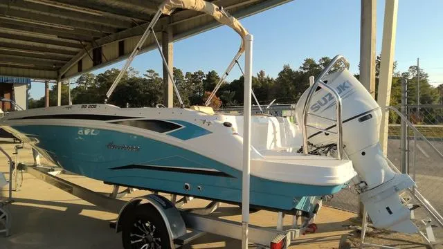 Slide: The Image of 2025 Hurricane SunDeck Sport 205 OB boat with Suzuki outboard motor on trailer. - 5
