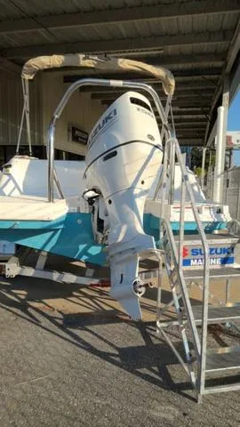 Slide: The Image of 2025 Hurricane SunDeck Sport 205 OB with Suzuki outboard motor in marina setting. - 6