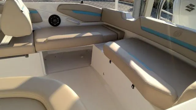 Slide: The Image of 2025 Hurricane SunDeck Sport 205 OB interior with beige seating and blue accents. - 8
