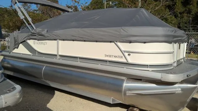 Slide: The Image of 2025 Godfrey Pontoons Sweetwater 2086 CSE covered pontoon boat, parked outdoors. - 1