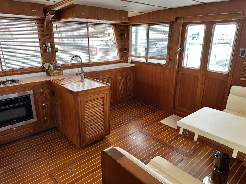 Slide: The Image of Luxurious 2023 Helmsman Trawlers 43E Pilothouse interior with wood finish and modern amenities. - 10