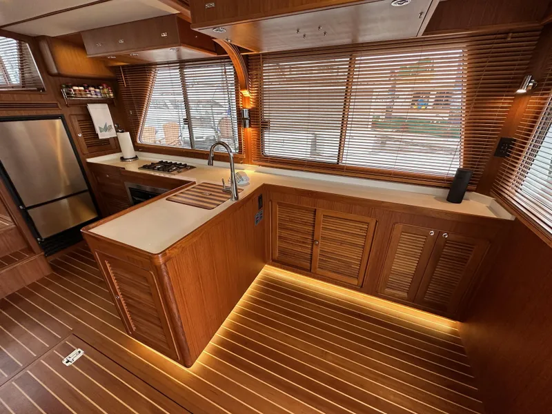 Slide: The Image of Luxurious 2023 Helmsman Trawlers 43E Pilothouse kitchen with wood finish and modern appliances. - 11