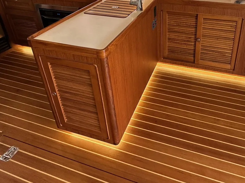Slide: The Image of Luxurious wood interior of 2023 Helmsman Trawlers 43E Pilothouse with ambient lighting. - 12