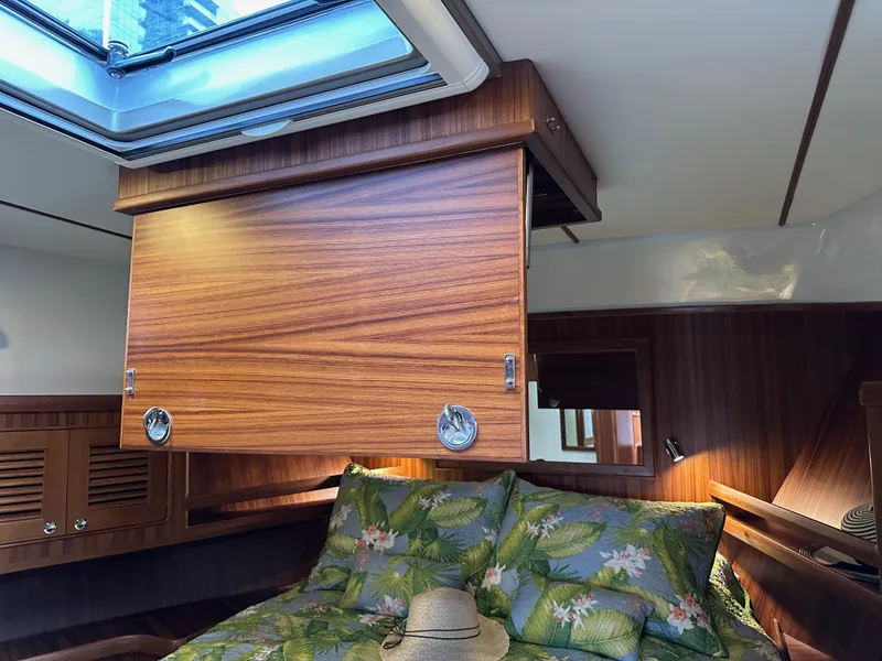 Slide: The Image of Luxurious cabin interior of 2023 Helmsman Trawlers 43E PILOTHOUSE with skylight and tropical bedding. - 27