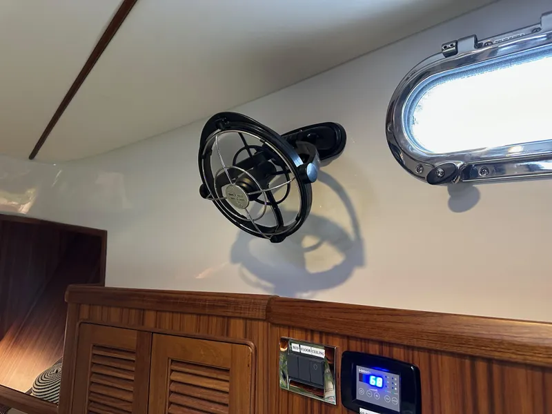 Slide: The Image of Wall-mounted fan and control panel inside 2023 Helmsman Trawlers 43E Pilothouse. - 29