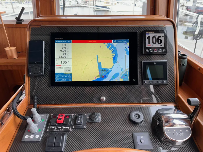 Slide: The Image of Helmsman Trawlers 43E PILOTHOUSE 2023 dashboard with navigation and control systems. - 36
