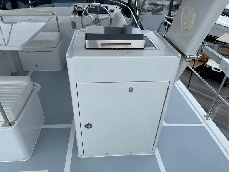 Slide: The Image of Helmsman Trawlers 43E PILOTHOUSE 2023 yacht deck with seating and grill station. - 44