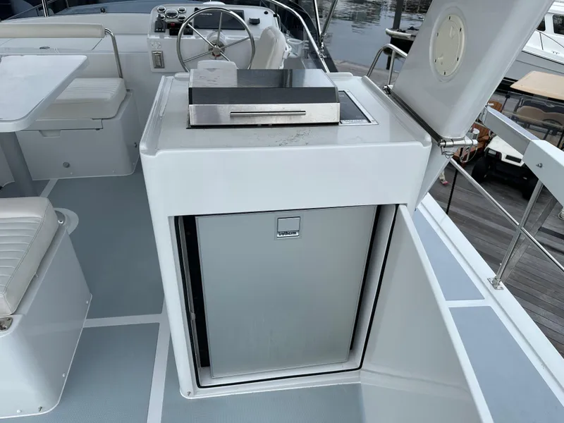 Slide: The Image of 2023 Helmsman Trawlers 43E PILOTHOUSE outdoor kitchen with grill and seating area. - 45