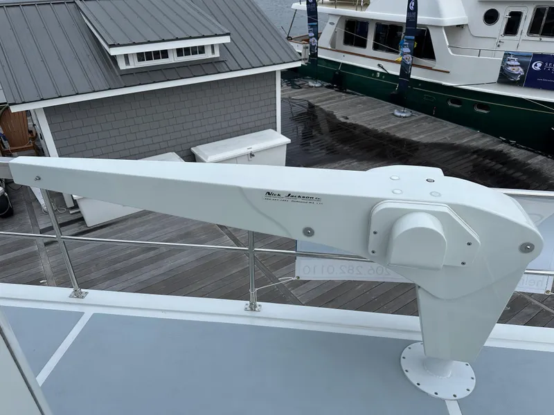 Slide: The Image of Helmsman Trawlers 43E PILOTHOUSE 2023 deck with davit crane, dockside view. - 49