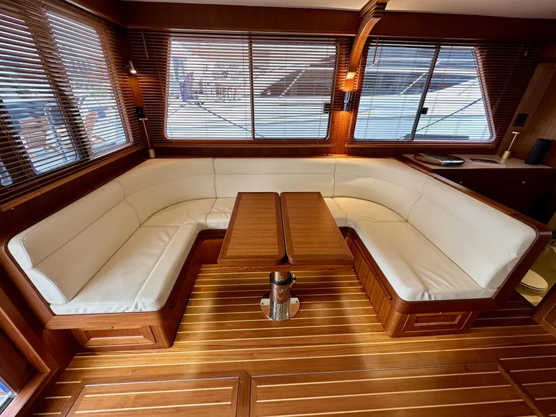 Slide: The Image of Luxurious interior of 2023 Helmsman Trawlers 43E Pilothouse with elegant wood and leather seating. - 8
