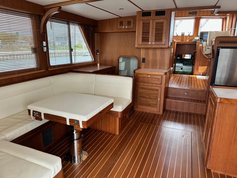 Slide: The Image of Luxurious 2023 Helmsman Trawlers 43E Pilothouse interior with wood finish and white seating. - 9
