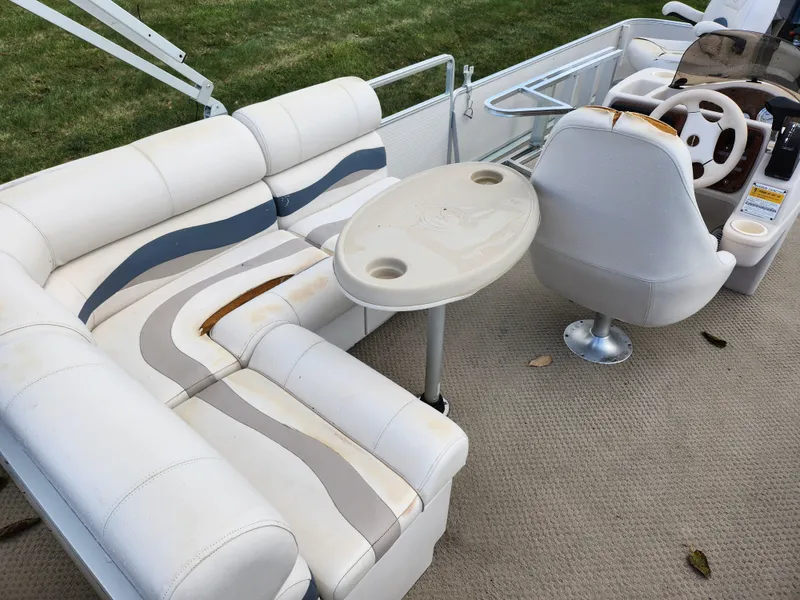 Slide: The Image of 2002 Harris FloteBote 220 Fisherman interior with white seating and table. - 20