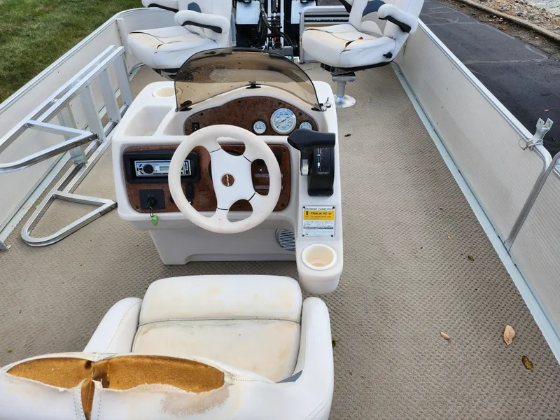 Slide: The Image of 2002 Harris FloteBote 220 Fisherman boat interior with steering console and seating. - 21