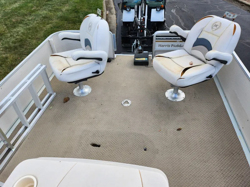 Slide: The Image of 2002 Harris FloteBote 220 Fisherman boat interior with swivel seats and clean deck. - 23