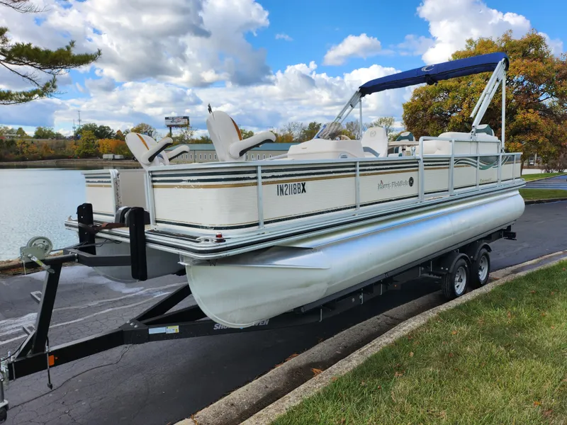 Slide: The Image of 2002 Harris FloteBote 220 Fisherman pontoon boat on trailer by a lake. - 8