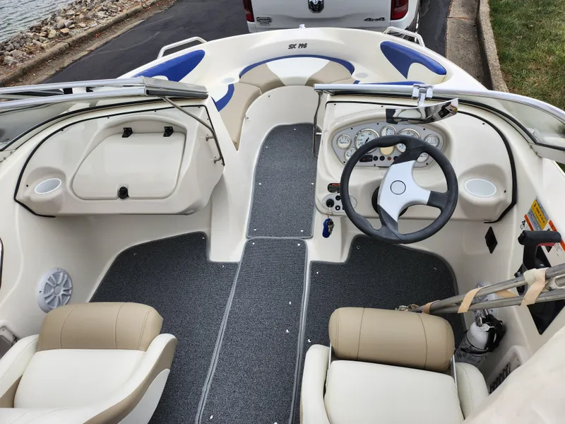 Slide: The Image of 2006 Glastron SX 195 boat interior with steering wheel and seating. - 11