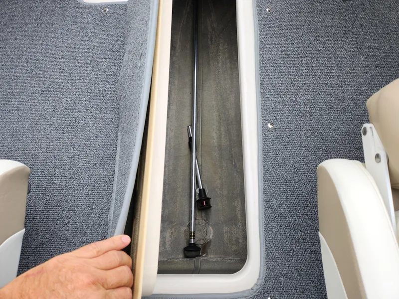 Slide: The Image of 2006 Glastron SX 195 boat storage compartment with carpeted interior. - 12