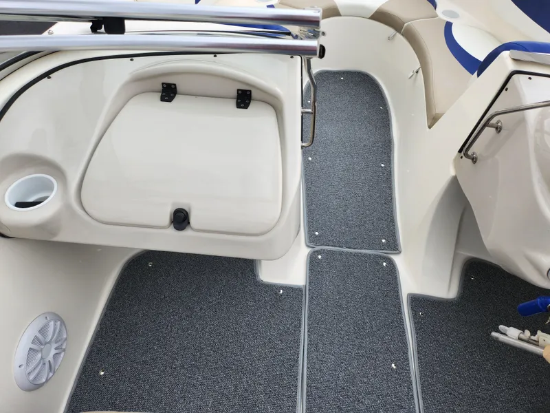 Slide: The Image of 2006 Glastron SX 195 boat interior with gray carpet and storage compartment. - 15