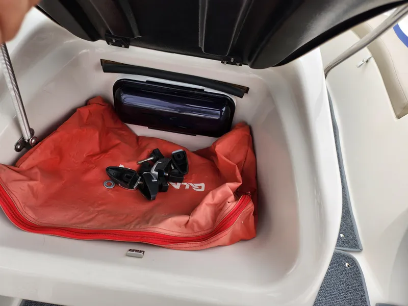 Slide: The Image of Storage compartment in 2006 Glastron SX 195 boat with orange bag and accessories. - 16