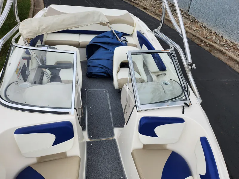 Slide: The Image of 2006 Glastron SX 195 boat interior with blue and white seating, open deck view. - 20
