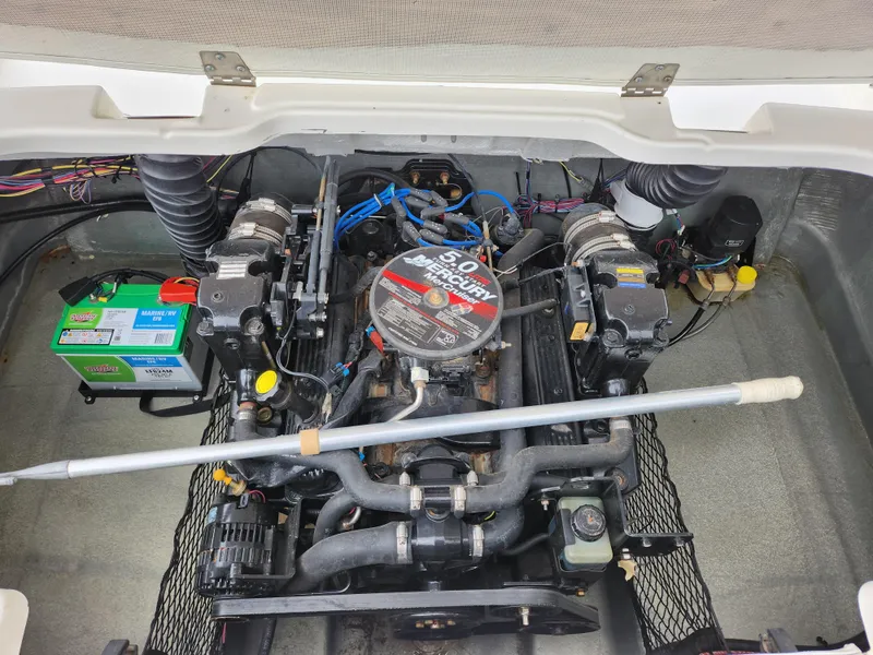 Slide: The Image of 2006 Glastron SX 195 engine compartment with visible battery and wiring. - 23