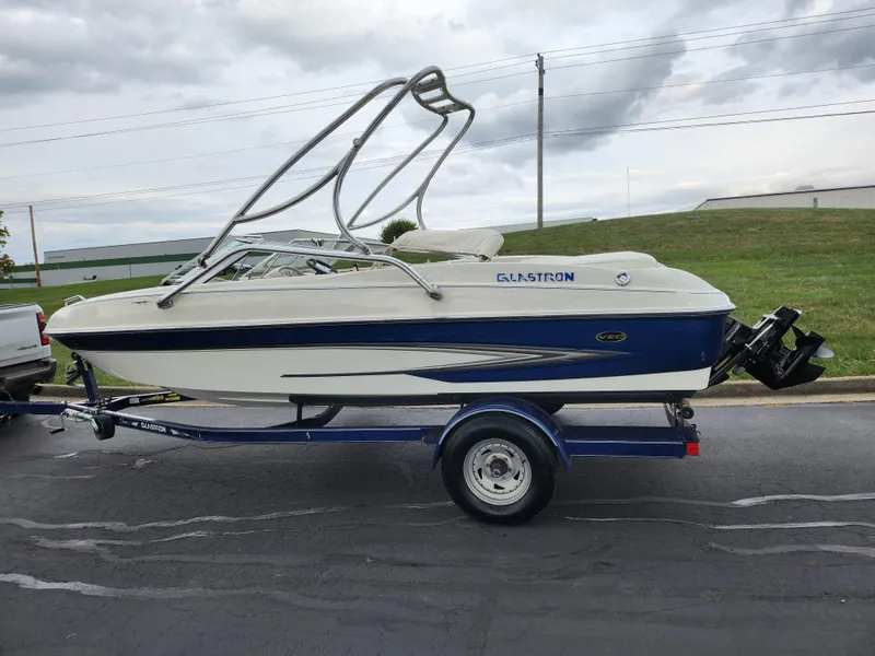Slide: The Image of 2006 Glastron SX 195 boat on trailer, parked on road. - 4