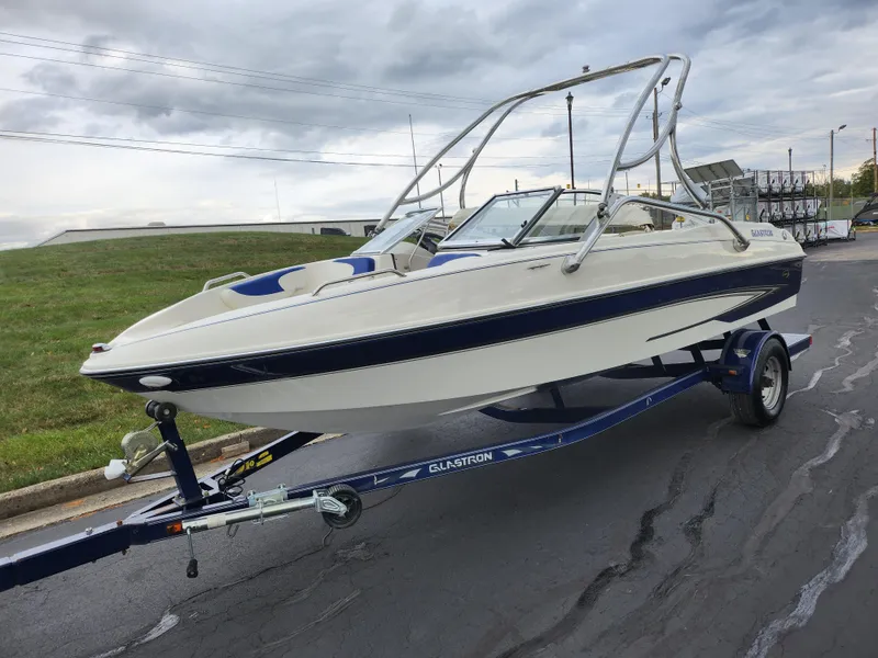 Slide: The Image of 2006 Glastron SX 195 boat on trailer, parked on paved road. - 5