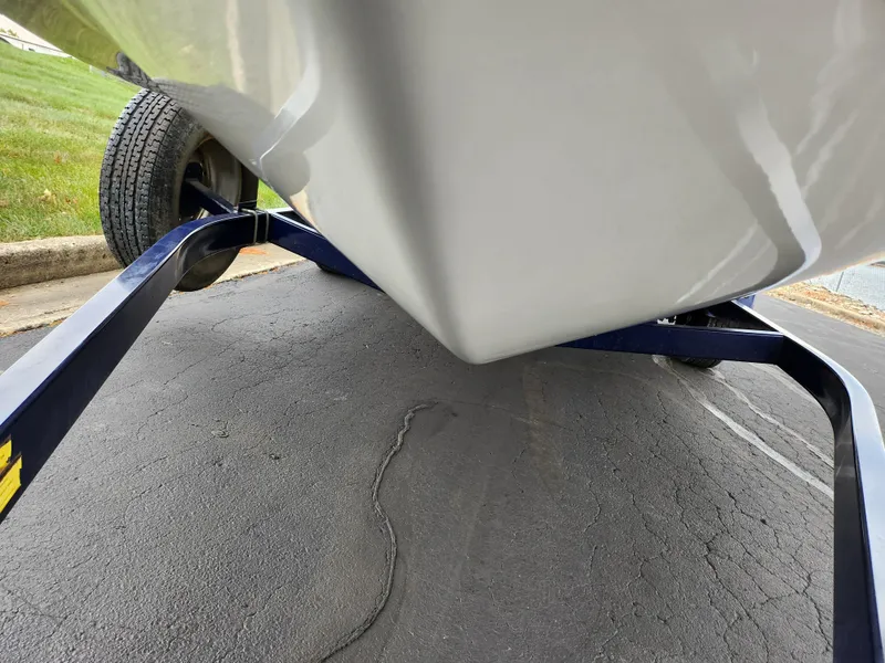 Slide: The Image of 2006 Glastron SX 195 boat on trailer, close-up view of hull and wheels. - 7