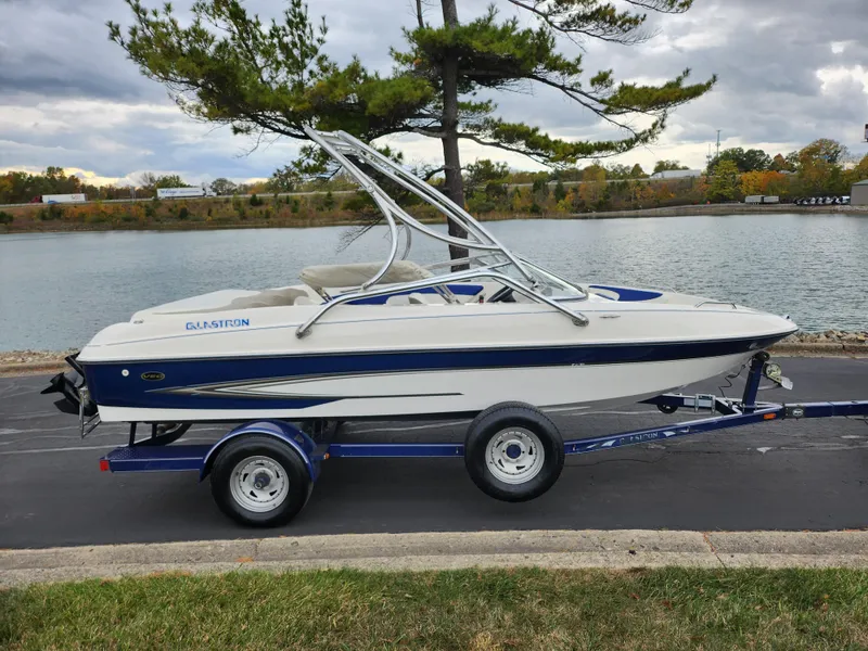 Slide: The Image of 2006 Glastron SX 195 boat on trailer by a lake, overcast sky. - 9