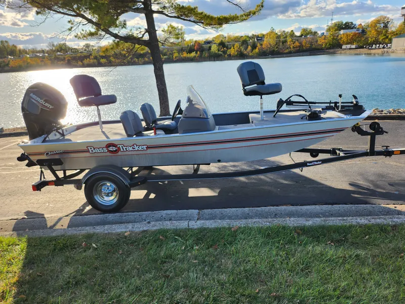 Slide: The Image of 2020 Tracker Bass Tracker Classic XL boat on trailer by a lake. - 11