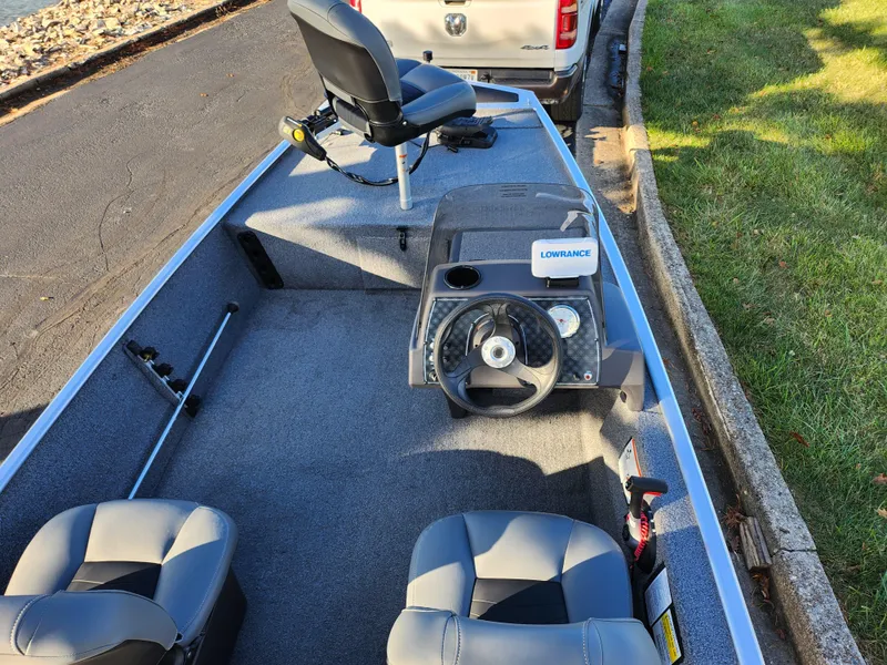 Slide: The Image of 2020 Tracker Bass Tracker Classic XL boat interior with steering wheel and seats. - 12