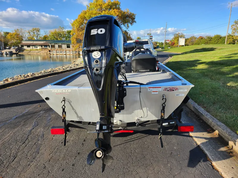 Slide: The Image of 2020 Tracker Bass Tracker Classic XL boat with 50 HP engine, parked near a lake. - 2