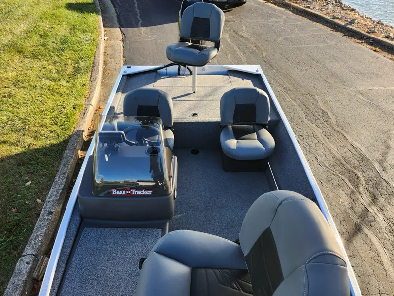 Slide: The Image of 2020 Tracker Bass Tracker Classic XL boat with seating, parked on a lakeside road. - 20
