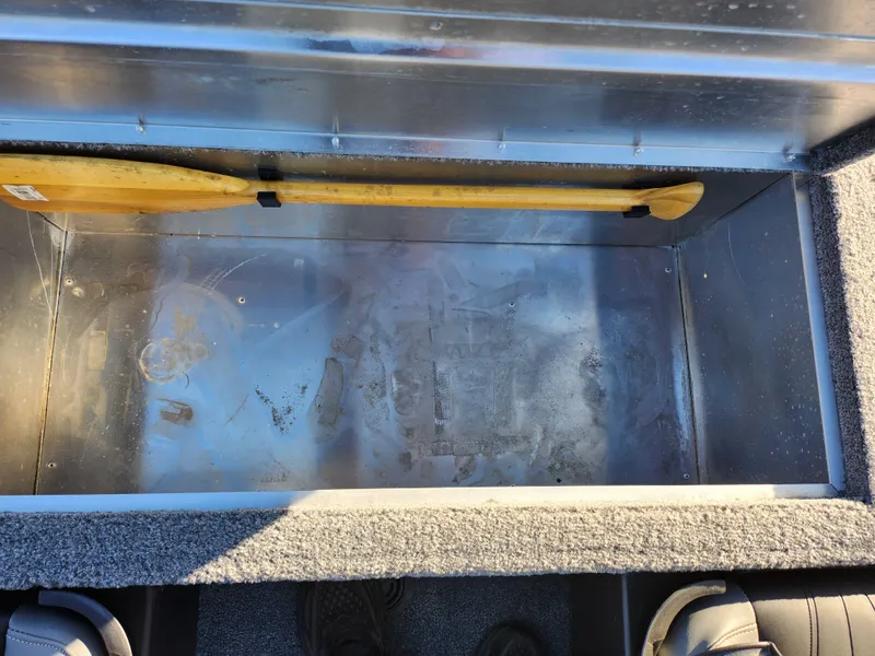 Slide: The Image of Storage compartment of 2020 Tracker Bass Tracker Classic XL boat with wooden paddle. - 24