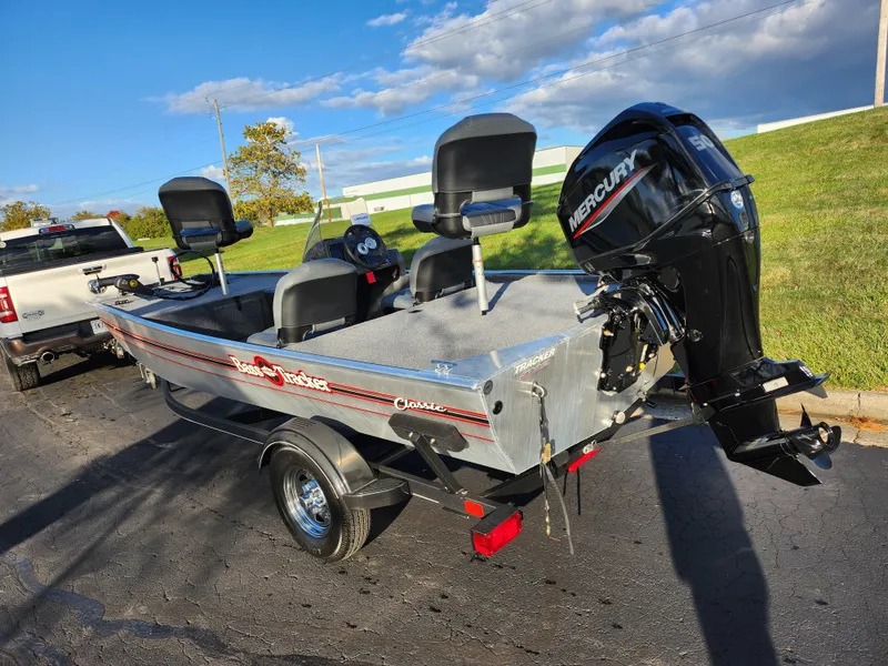 Slide: The Image of 2020 Tracker Bass Tracker Classic XL boat with Mercury engine on a trailer, parked outdoors. - 3