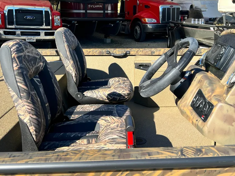 Slide: The Image of 2025 G3 Sportsman 1610 Vinyl boat interior with camo seats and steering wheel. - 14