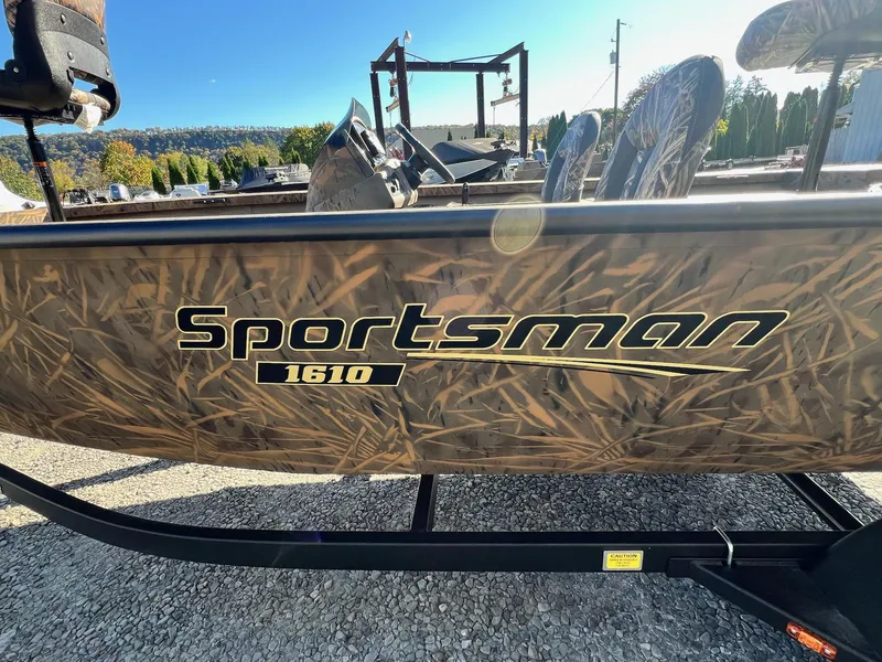 Slide: The Image of 2025 G3 Sportsman 1610 Vinyl boat with camouflage design on a sunny day. - 17