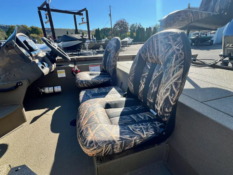 Slide: The Image of 2025 G3 Sportsman 1610 Vinyl boat interior with camo seats and steering wheel. - 19